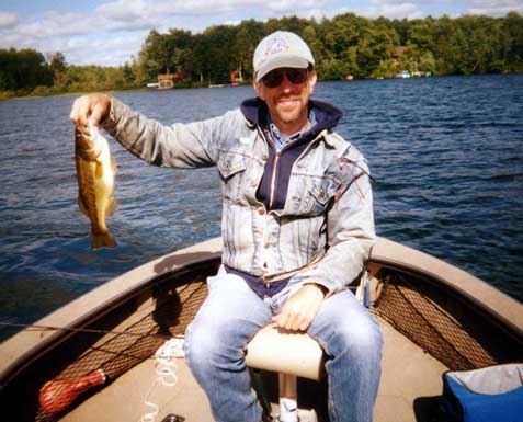 Harlan Terson and largemouth bass, Lac du Flambeau Chain, Wisconsin, August, 2002